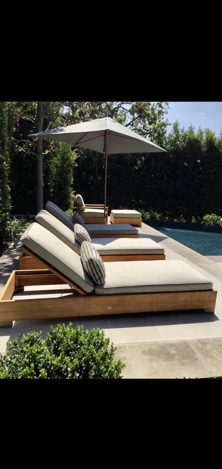 Teak pool lounges, custom outdoor cushions — Hillside estate