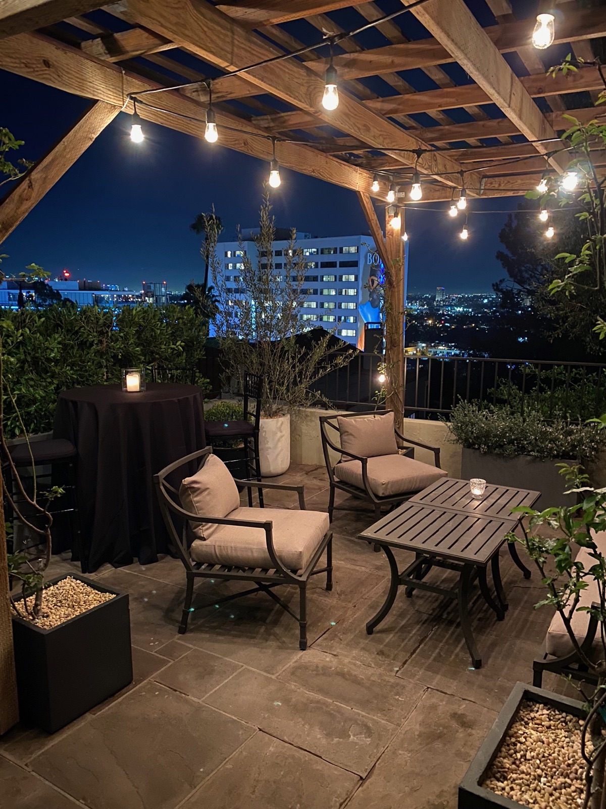 Rooftop lounge, string-light pergola — Los Angeles
